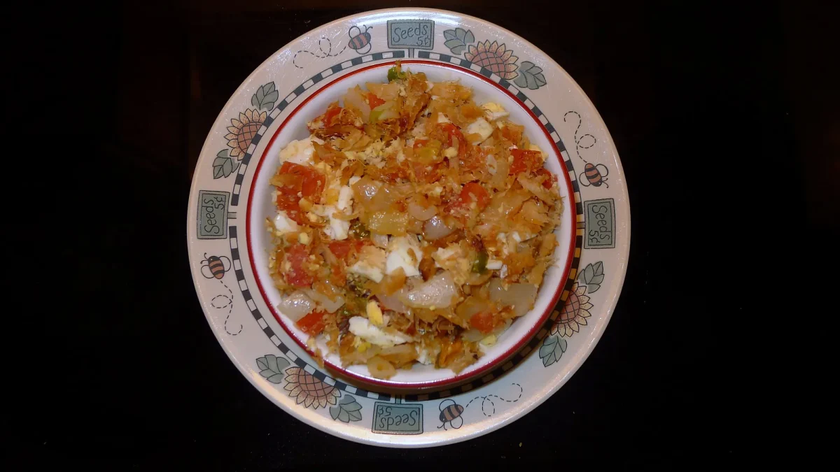 Saltfish buljol with tomato and onion on a decorated plate