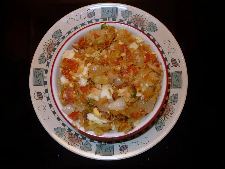 Saltfish buljol with tomato and onion on a decorated plate
