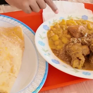 Dhalpuri roti with curry chicken, curried potato and channa