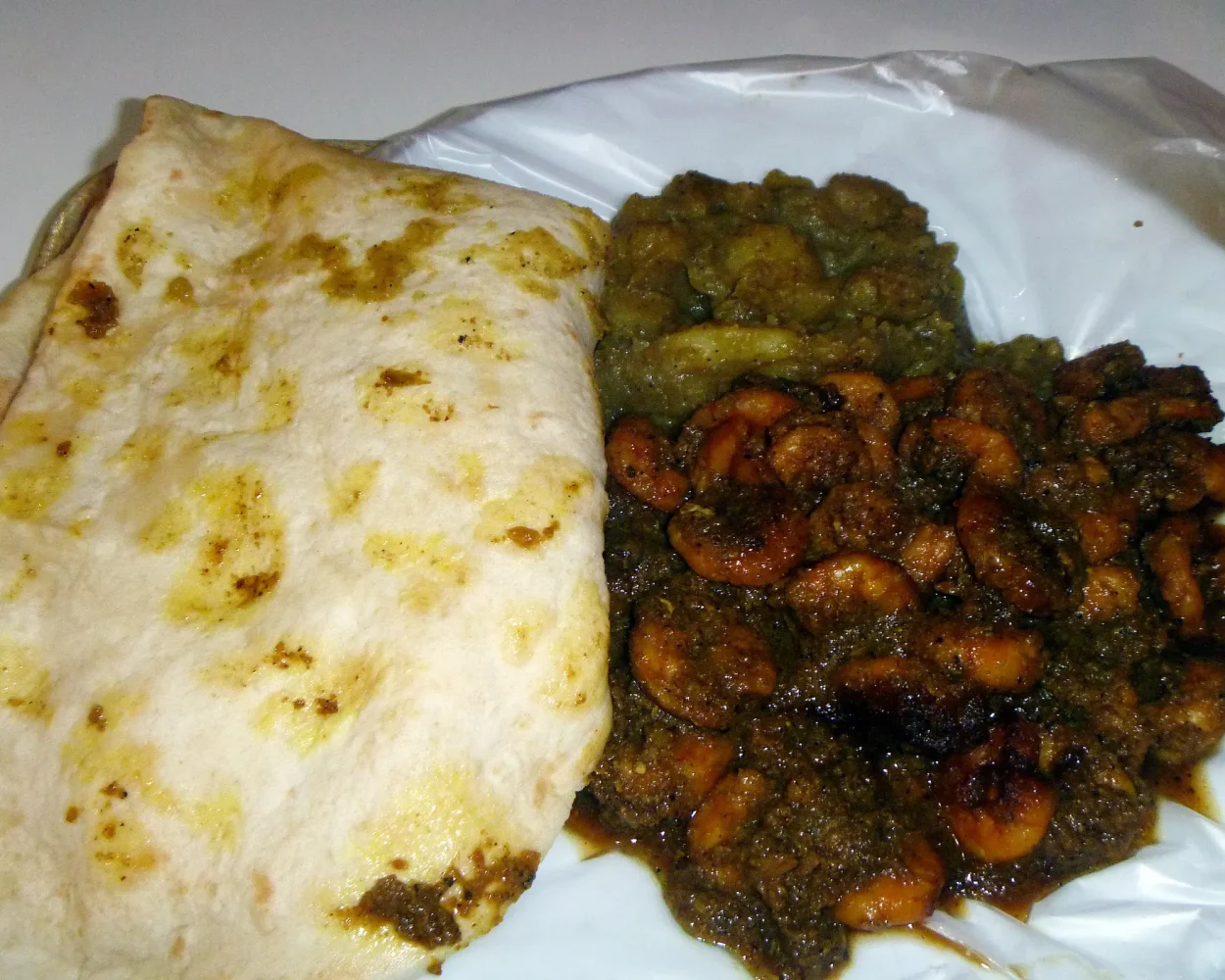 Dhalpuri roti with curry shrimp and curried channa and potato