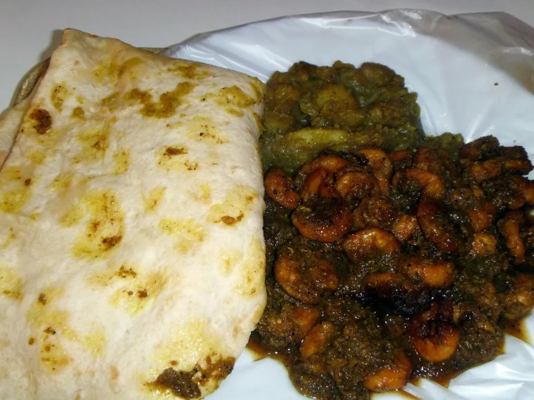 Dhalpuri roti with curry shrimp and curried channa and potato