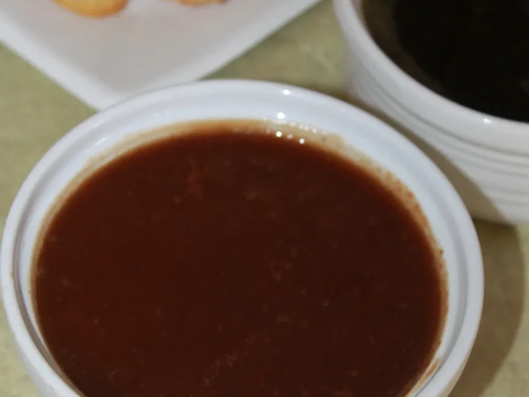 A bowl of dark, glossy tamarind chutney